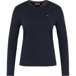 Bluzka Tommy Jeans Tjw Soft DW0DW06900. Różowe bluzki damskie Tommy Jeans, m, bez wzorów, z bawełny, bez kołnierzyka, bez rękawów. Za 179,00 zł.