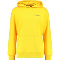 Calvin Klein Jeans HOROS 2 REGULAR POPOVER Bluza z kapturem spectra yellow. Żółte bluzy męskie rozpinane marki Calvin Klein Jeans, s, z bawełny, z kapturem. Za 499,00 zł.