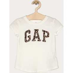 GAP - T-shirt dziecięcy 104-176 cm. Białe bluzki dziewczęce GAP, z aplikacjami, z bawełny, z okrągłym kołnierzem, z krótkim rękawem, krótkie, bez kaptura. Za 99,90 zł.
