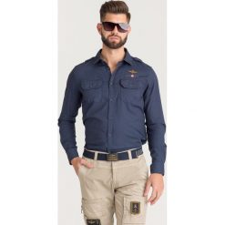 KOSZULA Aeronautica Militare. Niebieskie koszule męskie Aeronautica Militare, s, bez wzorów, z bawełny, z klasycznym kołnierzykiem, bez rękawów. Za 569,00 zł.
