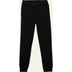 Guess Jeans - Spodnie dziecięce 118-175 cm. Niebieskie spodnie chłopięce Guess Jeans, z aplikacjami, z bawełny. Za 159,90 zł.