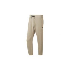 Spodnie treningowe Reebok Sport Spodnie dresowe Training Essentials 7/8. Brązowe spodnie męskie marki Reebok Sport, s, bez wzorów, z dresówki, sportowe. Za 229,00 zł.