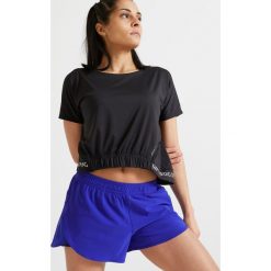 Koszulka fitness krótki rękaw 520 damska. Czarne t-shirty damskie DOMYOS, bez wzorów, z elastanu, bez kołnierzyka. Za 49,99 zł.