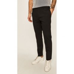 Calvin Klein - Spodnie. Czarne spodnie męskie Calvin Klein, bez wzorów, z elastanu. Za 599,90 zł.