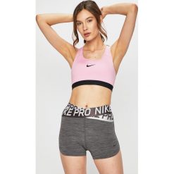 Nike - Biustonosz sportowy. Różowe biustonosze sportowe damskie Nike, xs, z nadrukiem, z elastanu, dri-fit (nike). W wyprzedaży za 119,90 zł.