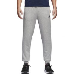 SPODNIE ESSENTIALS FRENCH TERRY. Spodnie męskie Adidas, na co dzień, m, bez wzorów, z dresówki, klasyczne. W wyprzedaży za 159,99 zł.