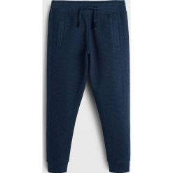 Mango Kids - Spodnie dziecięce Minioto 110-164 cm. Szare spodnie chłopięce Mango Kids, bez wzorów, z bawełny, casualowe. W wyprzedaży za 49,90 zł.