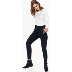Legginsy damskie, z suwakami. Czarne legginsy damskie TROLL, s, bez wzorów, z dzianiny. W wyprzedaży za 44,99 zł.