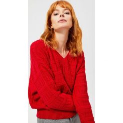 Sweter typu oversize o wyraźnym splocie. Czerwone swetry damskie Moodo, m, w ażurowe wzory, z bawełny, długie. Za 49,99 zł.