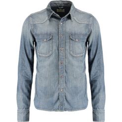Nudie Jeans JONIS Koszula denim. Niebieskie koszule męskie marki Nudie Jeans, xl, bez wzorów, z bawełny, bez kołnierzyka, bez rękawów. Za 539,00 zł.