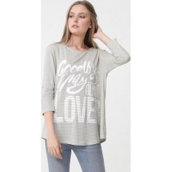 Jasnożółta Bluzka Kassidy. Żółte bluzki damskie Born2be, xl, w paski, z okrągłym kołnierzem, z długim rękawem. Za 39,99 zł.