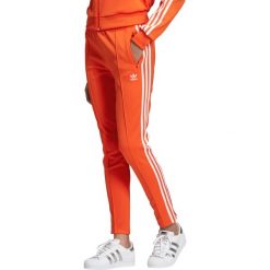 Adidas Originals SST Spodnie dresowe Czerwony Pomarańczowy. Czerwone spodnie damskie adidas Originals, z elastanu. Za 214,95 zł.