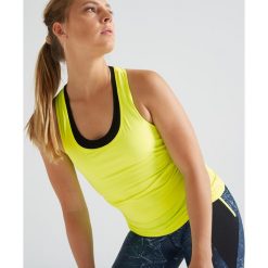 Top fitness kardio 100 damski. Niebieskie topy damskie DOMYOS, bez wzorów, z elastanu, bez kołnierzyka. Za 19,99 zł.