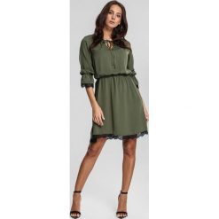 Ciemnozielona Sukienka Responsively. Zielone sukienki dziewczęce other, bez wzorów, z koronki, eleganckie, bez rękawów, mini, kopertowe. Za 64,99 zł.