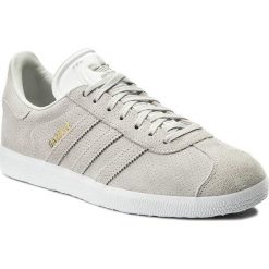 Buty adidas - Gazelle BZ0027 Greone/Greone/Goldmt. Brązowe buty sportowe damskie Adidas, w paski, z zamszu, bez obcasa, na płaskiej podeszwie, z paskami. W wyprzedaży za 259,00 zł.
