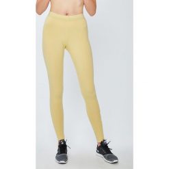 Nike Sportswear - Legginsy. Żółte legginsy damskie marki Nike Sportswear, s, z elastanu. W wyprzedaży za 79,90 zł.