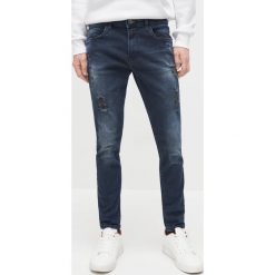 Spodnie jeansowe skinny - Granatowy. Niebieskie spodnie męskie Reserved, bez wzorów, z jeansu. Za 99,99 zł.