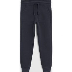 Mango Kids - Spodnie dziecięce Jumbo6 110-164 cm. Niebieskie spodnie chłopięce Mango Kids, bez wzorów, z bawełny. Za 69,90 zł.