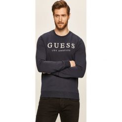 Guess Jeans - Bluza. Białe bluzy męskie Guess Jeans, xl, z aplikacjami, z elastanu, z okrągłym kołnierzem, bez rękawów, bez kaptura. W wyprzedaży za 199,90 zł.