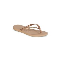 Japonki Havaianas SLIM LOGO METALLIC. Żółte klapki damskie Havaianas, bez wzorów, bez obcasa. Za 90,30 zł.