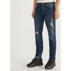 Jeansy slim fit z przetarciami - Niebieski. Niebieskie jeansy męskie relaxed fit marki QUECHUA, m, z elastanu. Za 149,99 zł.