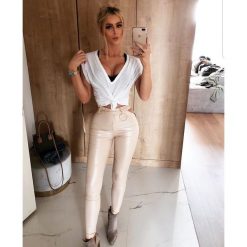Beżowe spodnie RING. Brązowe spodnie damskie Divinostyle, s, z bawełny. W wyprzedaży za 119,00 zł.