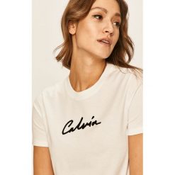 Calvin Klein Jeans - T-shirt. Czarne bluzki damskie Calvin Klein Jeans, s, z aplikacjami, z bawełny, z okrągłym kołnierzem, z krótkim rękawem. Za 229,90 zł.