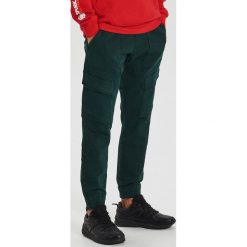 Spodnie slim jogger - Turkusowy. Niebieskie spodnie męskie Cropp, m. W wyprzedaży za 59,99 zł.