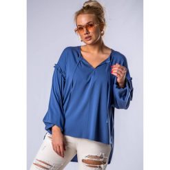 Oversize'owa bluzka z falbankami na rękawach, wiązaniem przy dekolcie i wydłużonym tyłem. Bluzki damskie producent niezdefiniowany, uniwersalny, bez wzorów, z bawełny, z falbankami, bez rękawów. Za 139,00 zł.