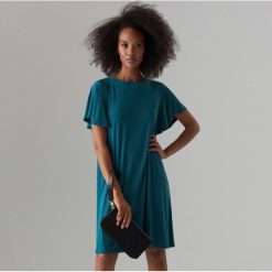 Trapezowa sukienka oversize - Turkusowy. Niebieskie sukienki damskie Mohito, s, bez wzorów, bez kołnierzyka, bez rękawów, trapezowe. Za 99,99 zł.