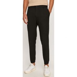 Calvin Klein - Spodnie. Czarne spodnie męskie Calvin Klein, bez wzorów, z elastanu. Za 579,90 zł.