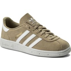 Buty adidas - Munchen CQ2324 Rawgol/Ftwwht/Goldmd. Brązowe buty sportowe damskie Adidas, bez wzorów, z zamszu, eleganckie, bez obcasa, na płaskiej podeszwie, bez zapięcia. W wyprzedaży za 299,00 zł.