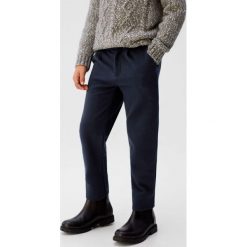 Mango Kids - Spodnie dziecięce Louise 110-164 cm. Niebieskie spodnie chłopięce Mango Kids, bez wzorów, z elastanu. W wyprzedaży za 49,90 zł.