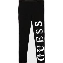 Guess Jeans - Legginsy dziecięce 118-175 cm. Czarne spodnie dziewczęce Guess Jeans, z nadrukiem, z elastanu. Za 129,90 zł.